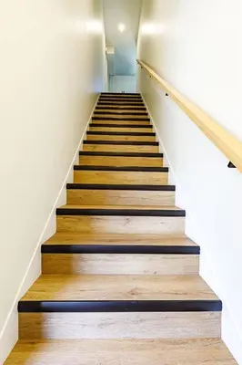 a staircase in a house with wooden floors at Ravens Nest - Private Hot Tub in Canmore