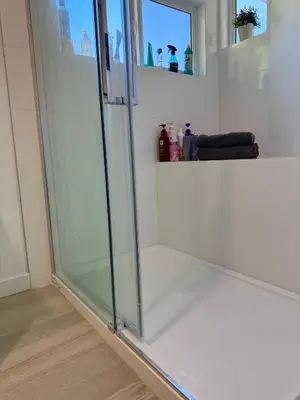 a shower stall with a glass door in a bathroom at Maple & Moon in Richmond