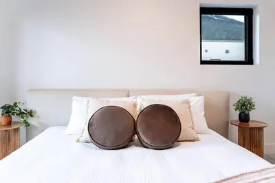 a bed with two oval pillows on it at Revelstoke Mountain Penthouse in Revelstoke