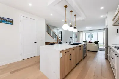 a kitchen with white walls and a white counter top at Luxury Home Near DT, New Build, High-End Features in Calgary