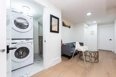 a white laundry room with a washer and dryer at Newly built 2 bedroom suite with kitchen & laundry in Calgary
