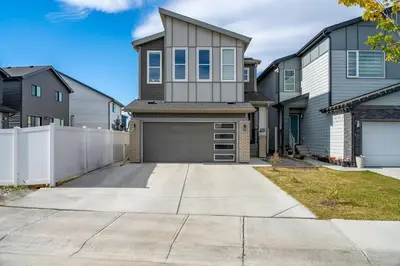 a house with a garage in a residential neighborhood at 2BR Stylish & Private Suite SE! FREE Banff Pass, Netflix, Parking! in Calgary