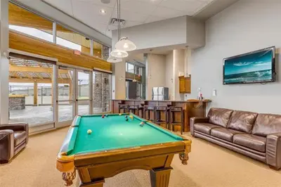 a living room with a pool table in it at Copper Sky Paradise in West Kelowna