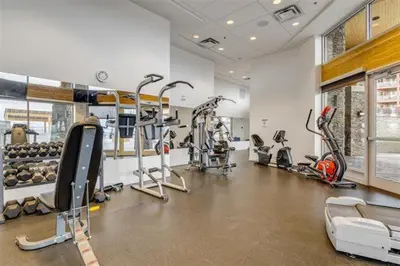 a gym with treadmills and exercise bikes in a room at Copper Sky Paradise in West Kelowna
