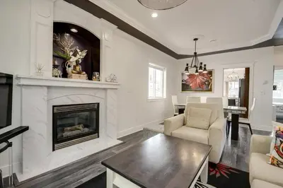 a living room with a fireplace and a table and chairs at Spacious Family Home in Vancouver in Vancouver