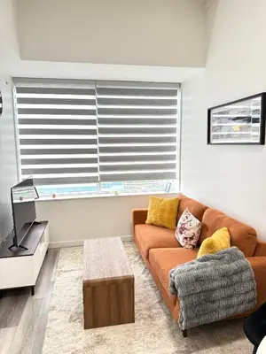 a living room with a couch and a table at Cozy 1-Bedroom with Downtown City views in Edmonton