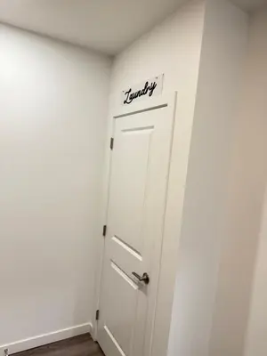 a white door with the word laundry written on it at Cozy 1-Bedroom with Downtown City views in Edmonton