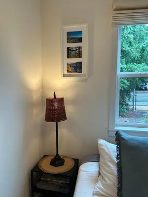 a lamp sitting on a table next to a couch at Studio Cedar Guest Cottage in Duncan