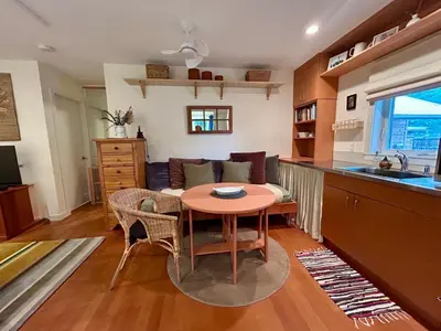 a kitchen and living room with a table and a couch at Studio Cedar Guest Cottage in Duncan