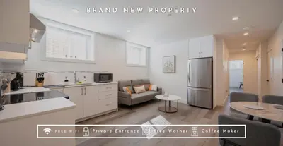 a kitchen and living room with a couch and a refrigerator at Relaxing 2BR Stay - Kitchen & Central Convenience in Vancouver