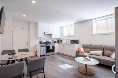 a living room with a couch and a table at Relaxing 2BR Stay - Kitchen & Central Convenience in Vancouver