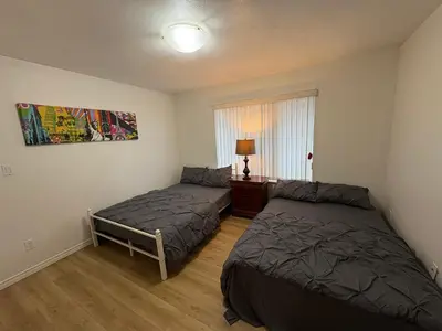 a bedroom with two beds and a window at Vancouver Home - Downtown 15 Min, Transit Access - Free Parking & Wi-Fi in Vancouver