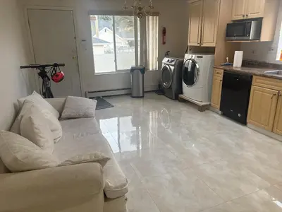 a living room with a couch and a kitchen at Vancouver Home - Downtown 15 Min, Transit Access - Free Parking & Wi-Fi in Vancouver