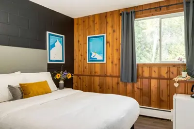 a bedroom with a white bed and a window at Gateway Suites Rocky Mountains stay near Banff in Canmore