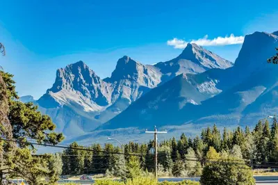 a mountain range with a cross in the foreground at Gateway Suites Rocky Mountains stay near Banff in Canmore