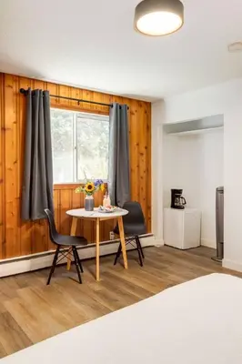 a room with a table and two chairs and a window at Gateway Suites Perfect rest on your way to Banff in Canmore