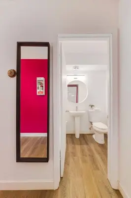 a bathroom with a toilet and a mirror at Gateway Suites Perfect rest on your way to Banff in Canmore