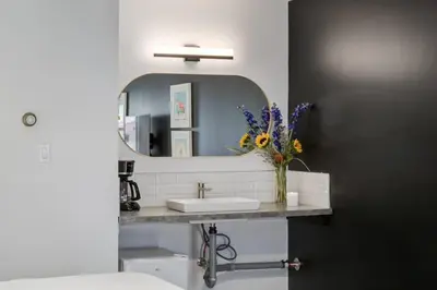 a bathroom with a sink and a mirror at Gateway Suites Charming Stay perfect for 4 Guests in Canmore