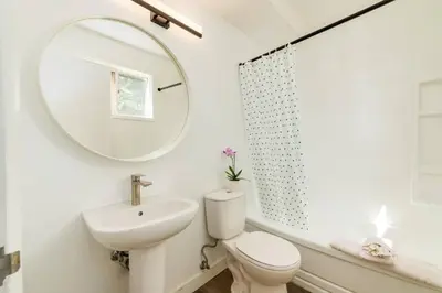 a bathroom with a sink toilet and a mirror at Gateway Suites near Banff in Canmore