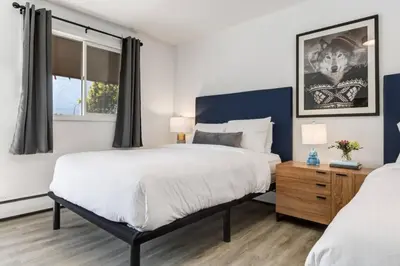 a bedroom with two beds and a window at Gateway Suites Perfect Escape to explore Banff in Canmore