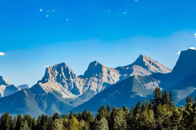 a mountain range with trees in the foreground at Gateway Suites Lovely views near Banff in Canmore