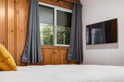 a bedroom with a bed and a window at Gateway Suites Sweet Getaway near Canmore and Banff in Canmore