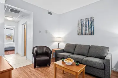 a living room with a couch and a table at Stylish 1BR Haven in CanmoreDT near Banff Sleeps 4 in Canmore