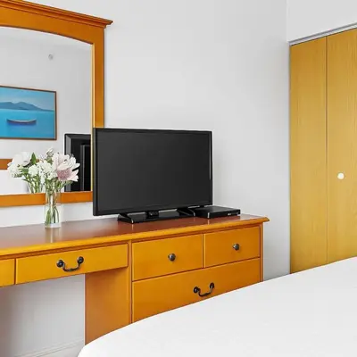 a television on a dresser in a bedroom at Stylish 1BR Haven in CanmoreDT near Banff Sleeps 4 in Canmore