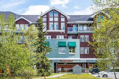 an apartment building with red and green at Stylish 1BR Haven in CanmoreDT near Banff Sleeps 4 in Canmore