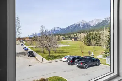 a view from a window of a parking lot with cars at Stylish 1BR Haven in CanmoreDT near Banff Sleeps 4 in Canmore