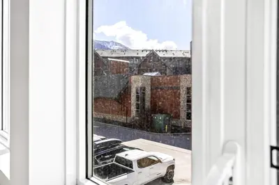 a view from a window with a car parked outside at Mini Getaway with Mountain Views Near Banff in Canmore