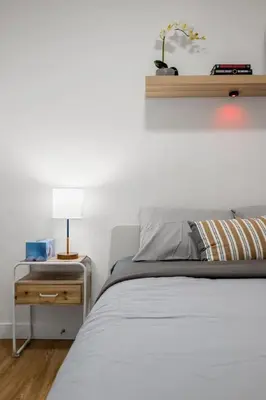 a bedroom with a bed and a table with a lamp at Modern 2BR Private Suite Near Calgary Airport in Calgary