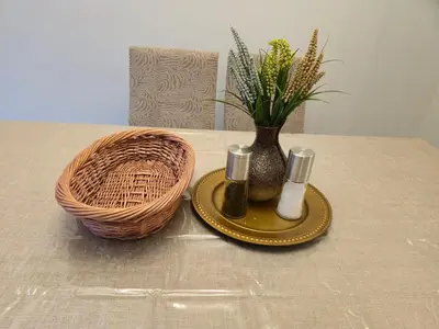 a table with a vase of flowers and a basket at Sunny's Homes in Edmonton