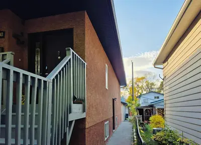 a brick building with a staircase on the side of it at Central 3 Bedroom Gem Near ICE District - Stadium and Malls in Edmonton