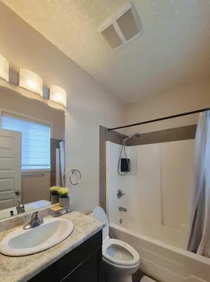 a bathroom with a sink and a toilet and a shower at Central 3 Bedroom Gem Near ICE District - Stadium and Malls in Edmonton