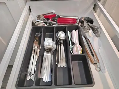 a tray with silver utensils in a drawer at Kirvia's retreat 