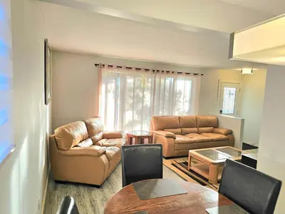 a living room with two leather chairs and a table at Kirvia's retreat 