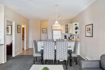a kitchen and living room with a table and chairs at The Pinnacle in Fairmont 1BR Condo Near Hot Springs in Fairmont Hot Springs