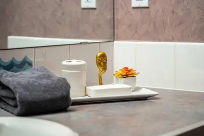 a bathroom counter with a plate with a gold spoon at The Pinnacle in Fairmont 1BR Condo Near Hot Springs in Fairmont Hot Springs