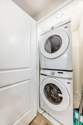 a laundry room with a washer and dryer at KimzNest in Edmonton