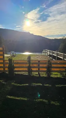 a fence in a field with the sun in the background at Lakeview Escape in Northshore Estates in Lake Cowichan