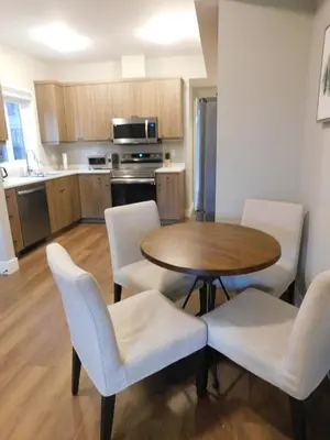 a kitchen and dining room with a table and chairs at Lakeview Escape in Northshore Estates in Lake Cowichan