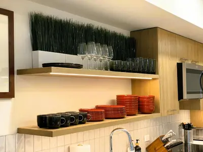 a kitchen with plates and glasses on a shelf at Black Bears Den, Heated Pool, Hot Tub, Brand NEW! in Canmore