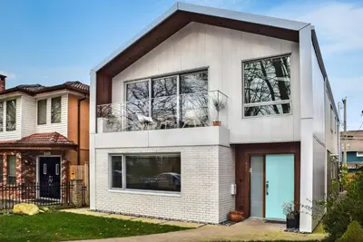 a white brick house with black windows at Modern Private Suite with Parking - Cambie Village VGH in Vancouver