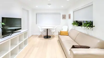 a living room with a couch and a table at Modern Private Suite with Parking - Cambie Village VGH in Vancouver