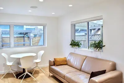 a living room with a couch and a table at Modern Private Suite with Parking - Cambie Village VGH in Vancouver
