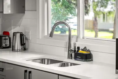 a kitchen counter with a sink and a window at Bright 5-Bed Retreat Near the Zoo and Downtown in Calgary