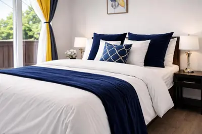 a bedroom with a blue and white bed and a window at Bright 5-Bed Retreat Near the Zoo and Downtown in Calgary