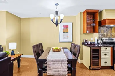 a kitchen and dining room with a table and chairs at Exciting Rockies 1BR Escape with Hot Tub, Pool and BBQ in Canmore