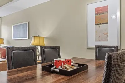 a table with a tray with cups and cookies on it at Mountain View Escape Sleeps 6 with Hot Tub and Pool in Canmore